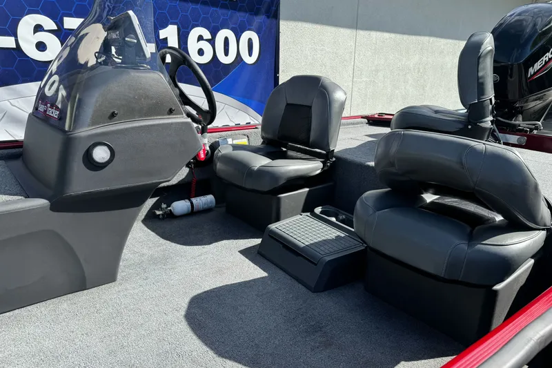 Slide: The Image of 2025 Tracker Bass Tracker Classic XL boat interior with seating and steering console. - 17
