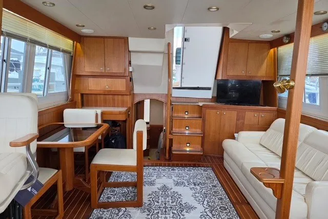 Slide: The Image of Interior of 2002 Mainship 430 Trawler with wood furnishings and cozy seating area. - 7