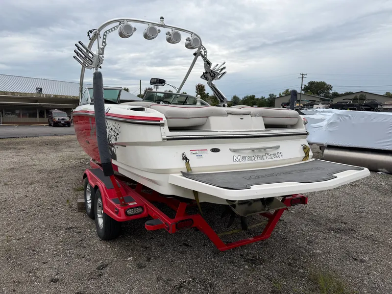 Slide: The Image of A 2010 MasterCraft X25 boat on a red trailer, featuring a tower and speakers. - 14
