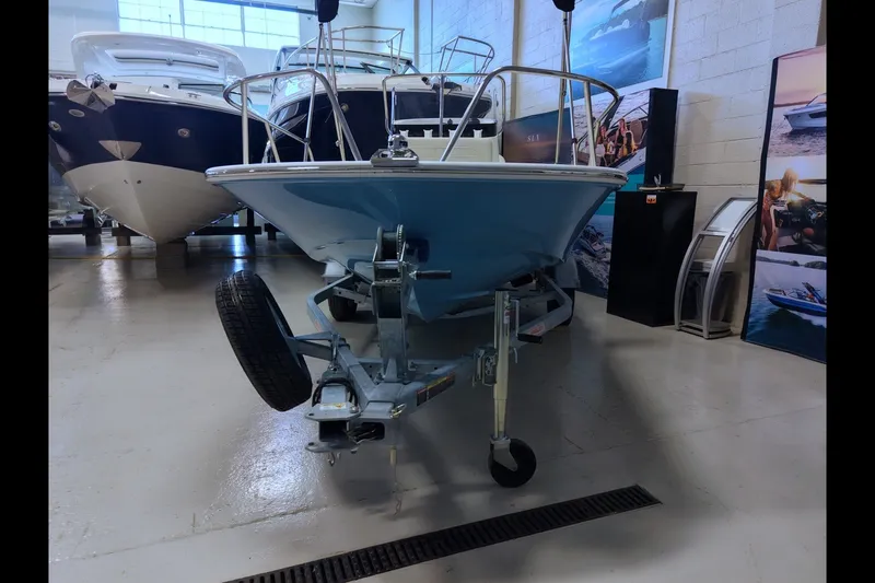 Slide: The Image of 2027 Boston Whaler 150 Montauk boat on trailer in showroom. - 3