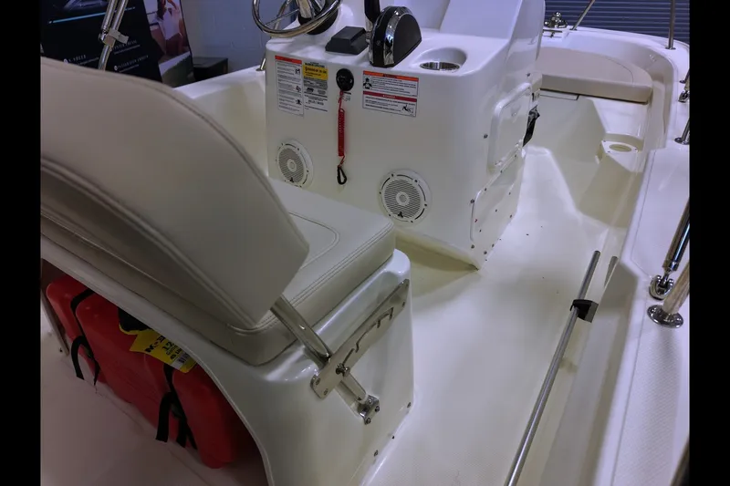 Slide: The Image of 2027 Boston Whaler 150 Montauk interior with seating and control console. - 7