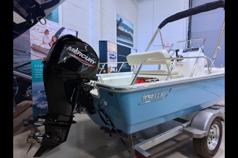 The Image of 2027 Boston Whaler 150 Montauk boat with Mercury engine on display in showroom. - 0