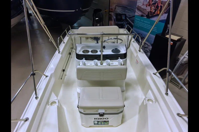 Slide: The Image of 2027 Boston Whaler 150 Montauk interior with seating and cooler, showcasing sleek design. - 5