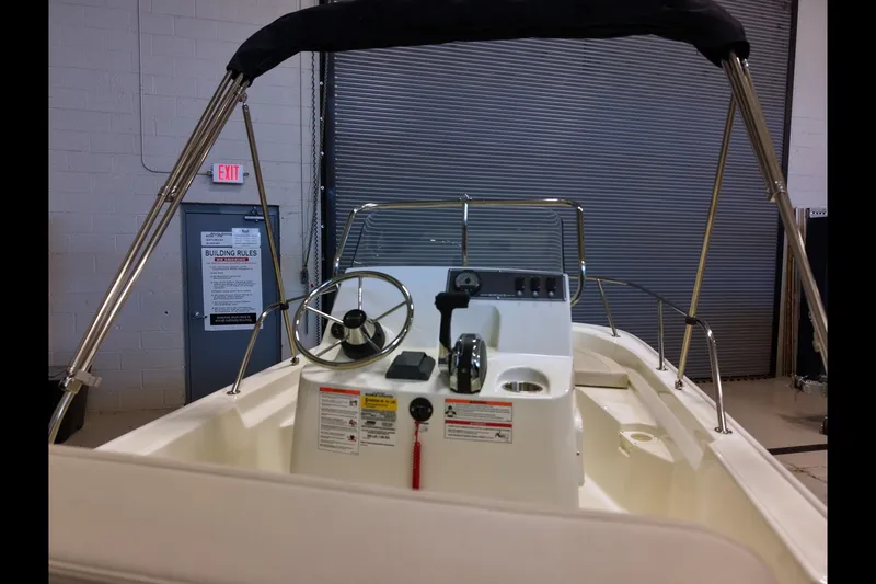 Slide: The Image of 2027 Boston Whaler 150 Montauk boat interior with steering wheel and controls. - 8