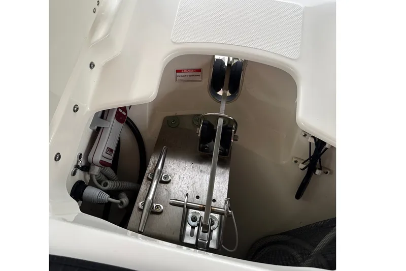 Slide: The Image of 2019 Boston Whaler 270 Vantage anchor compartment with winch and wiring. - 29