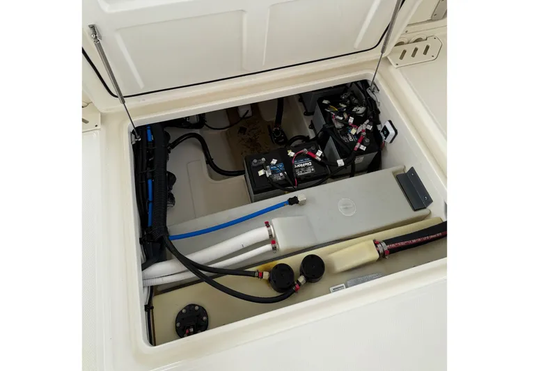 Slide: The Image of 2019 Boston Whaler 270 Vantage boat storage compartment with wiring and battery setup. - 26