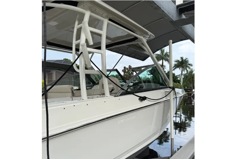 Slide: The Image of 2019 Boston Whaler 270 Vantage boat docked near palm trees. - 4