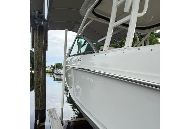 Slide: The Image of 2019 Boston Whaler 270 Vantage boat docked under a canopy. - 5