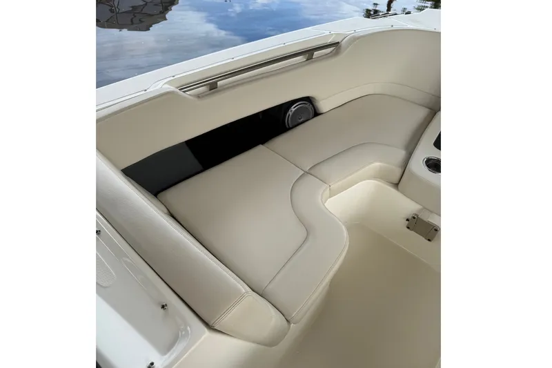 Slide: The Image of 2019 Boston Whaler 270 Vantage boat interior with beige seating and cup holder. - 16