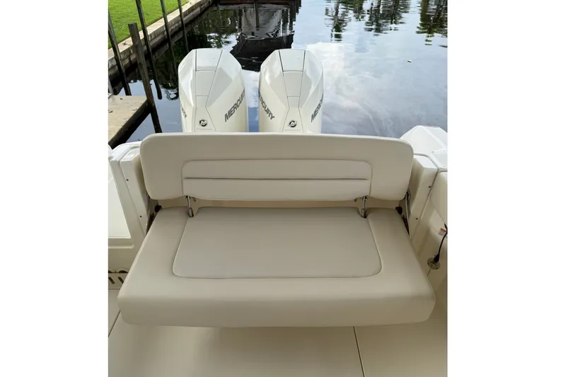 Slide: The Image of 2019 Boston Whaler 270 Vantage boat with dual Mercury engines and cushioned seating. - 23