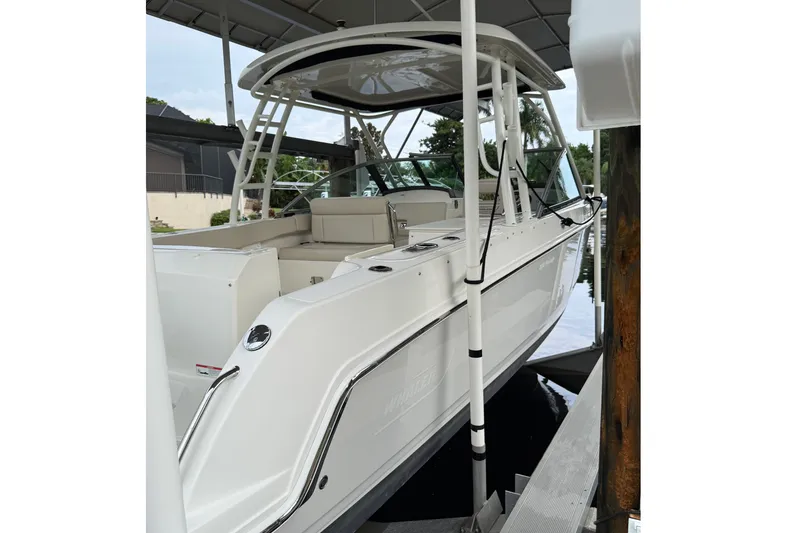 Slide: The Image of 2019 Boston Whaler 270 Vantage boat docked under a canopy. - 3
