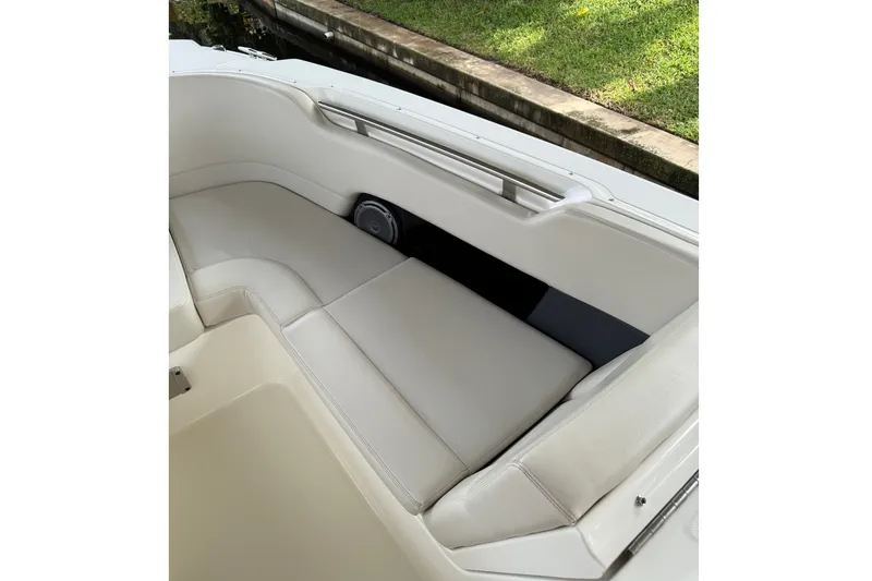Slide: The Image of 2019 Boston Whaler 270 Vantage boat interior with cushioned seating and speaker. - 15