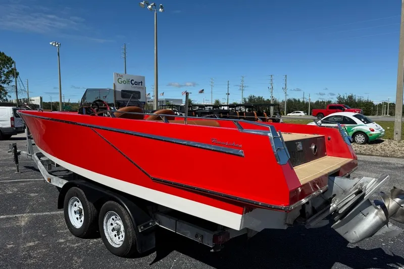 Slide: The Image of Red 2007 Frauscher 686 Lido boat on trailer, parked outdoors under clear sky. - 32