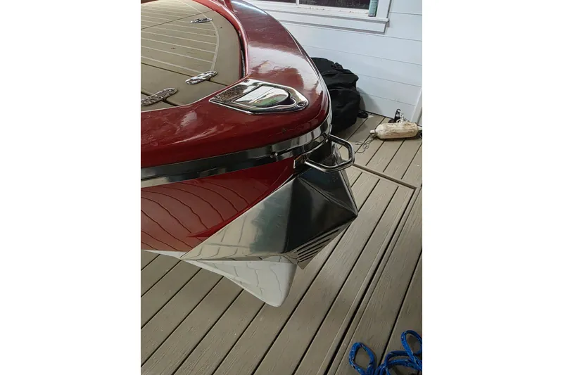Slide: The Image of 2007 Frauscher 686 Lido boat bow with red and silver detailing on a wooden dock. - 22