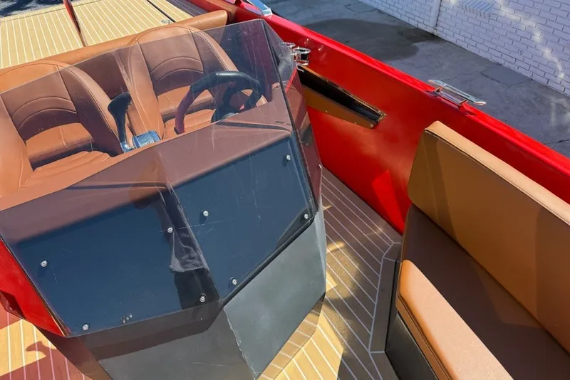 Slide: The Image of 2007 Frauscher 686 Lido boat interior with brown seating and red accents. - 7