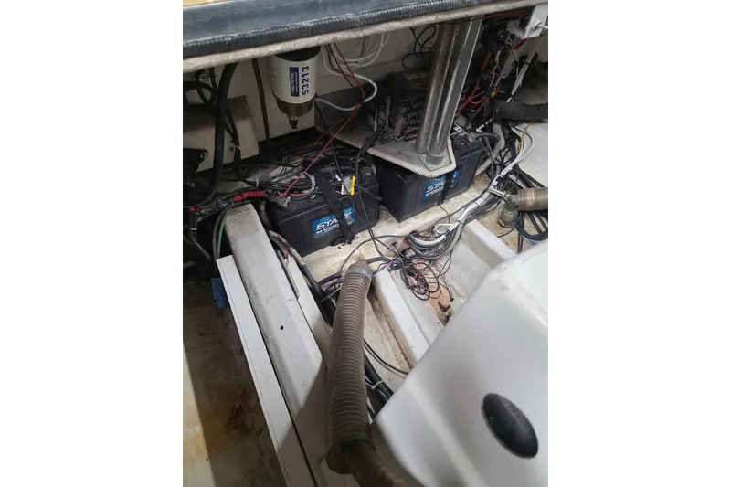 Slide: The Image of Engine compartment of a 2007 Frauscher 686 Lido boat, showing batteries and wiring. - 24