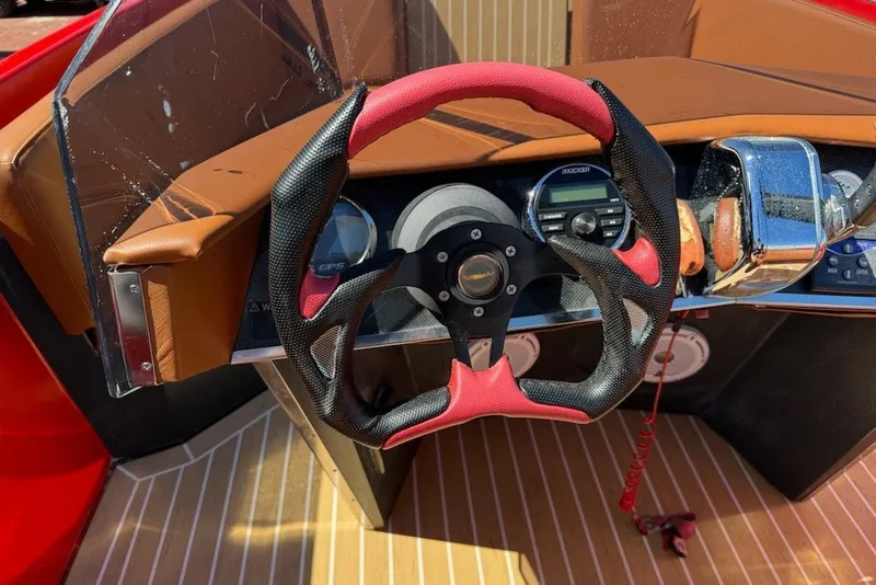 Slide: The Image of Steering wheel and dashboard of 2007 Frauscher 686 Lido boat with red accents. - 10
