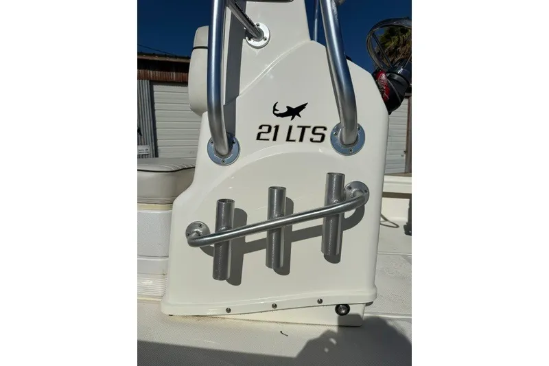 Slide: The Image of 2015 Mako 21 LTS boat console with rod holders and logo. - 8