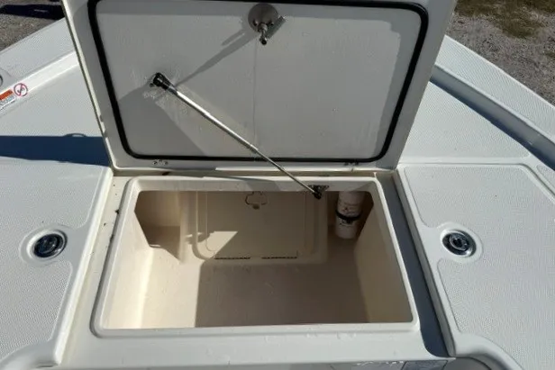 Slide: The Image of Open storage compartment on a 2015 Mako 21 LTS boat deck. - 19