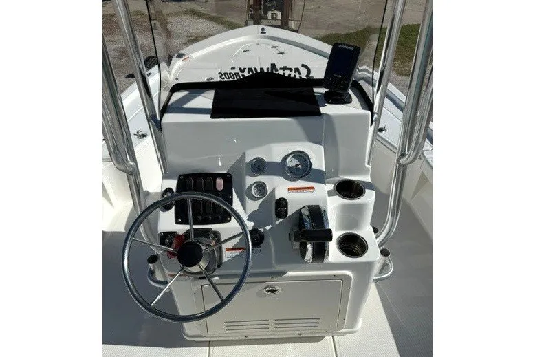 Slide: The Image of The image shows the helm of a Mako 21 LTS boat with various instruments and controls. - 5