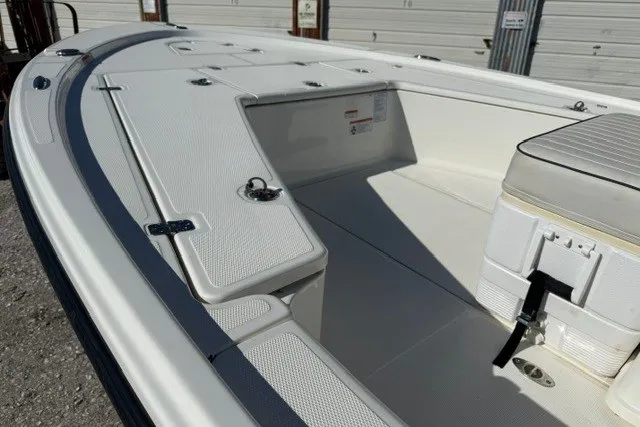 Slide: The Image of 2015 Mako 21 LTS boat deck with storage compartments and seating area. - 16