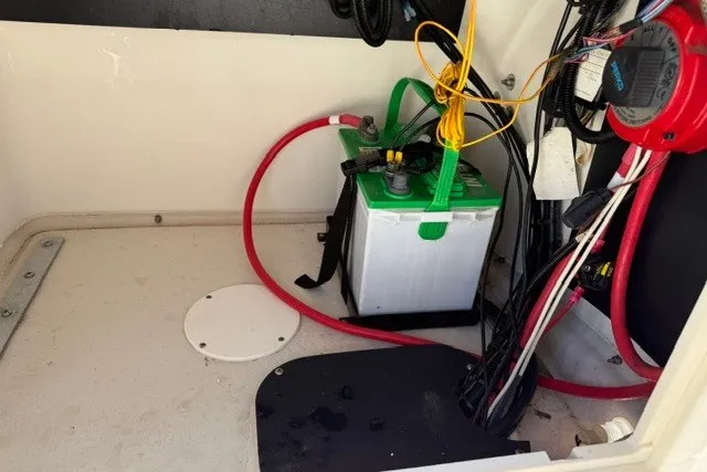 Slide: The Image of Battery compartment of a 2015 Mako 21 LTS boat with wiring and connections. - 7