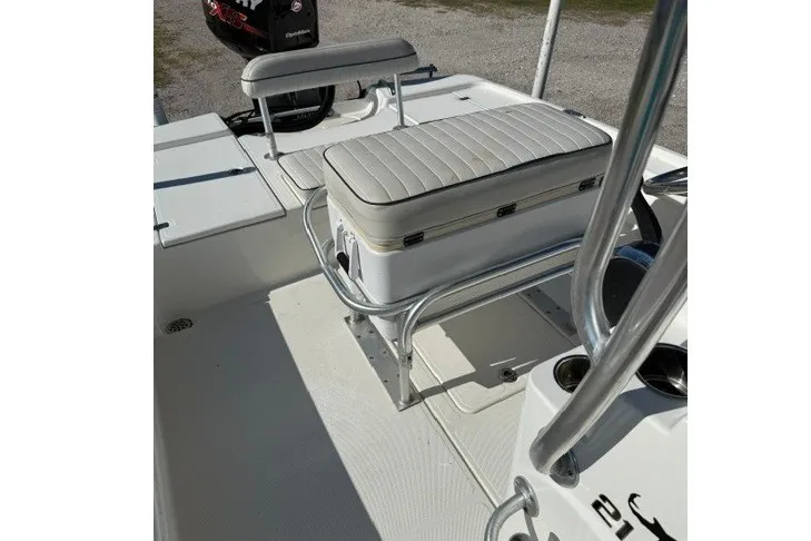 Slide: The Image of 2015 Mako 21 LTS boat interior with seating and storage compartments. - 12