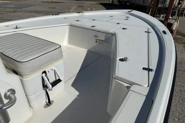 Slide: The Image of 2015 Mako 21 LTS boat interior with seating and storage compartments. - 15