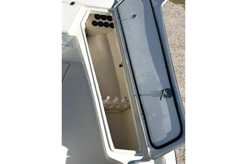 Slide: The Image of Open storage compartment on a 2015 Mako 21 LTS boat, showing interior details. - 18