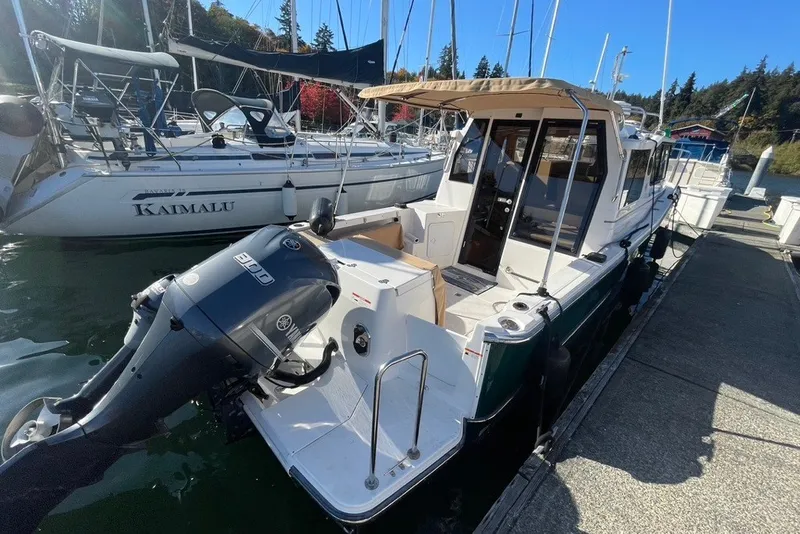 Slide: The Image of 2018 Ranger Tug R-27 docked with Yamaha outboard motor, sunny marina setting. - 3