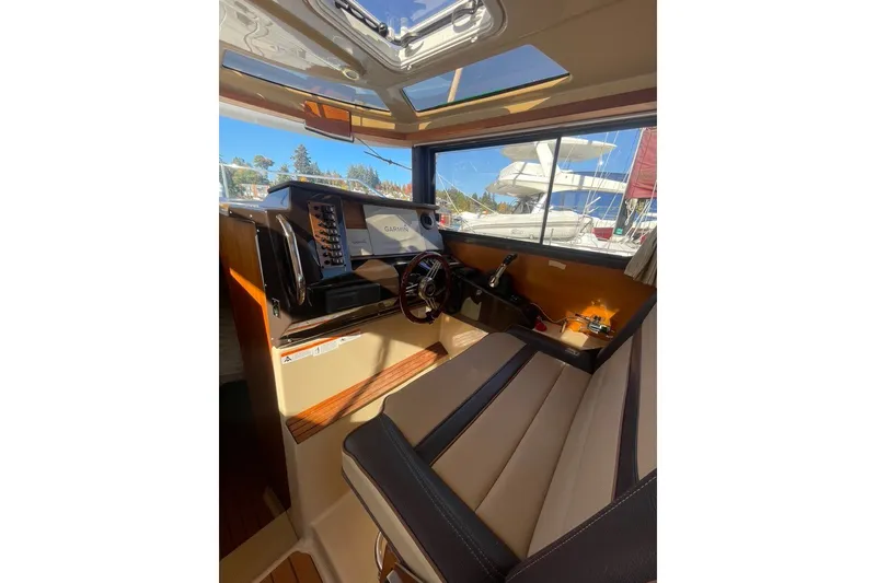 Slide: The Image of Interior of 2018 Ranger Tug R-27 boat with navigation equipment and seating. - 11