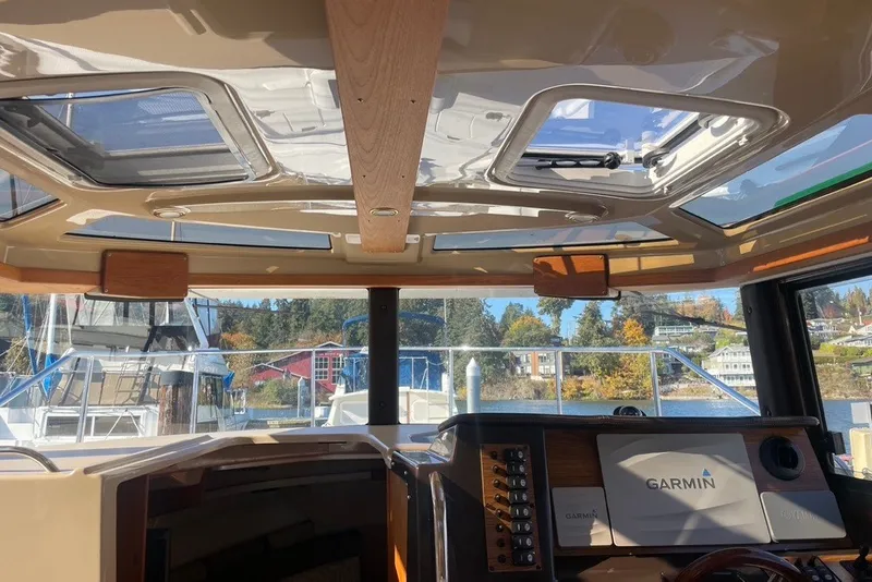 Slide: The Image of Interior view of 2018 Ranger Tug R-27 with Garmin navigation system and skylights. - 34