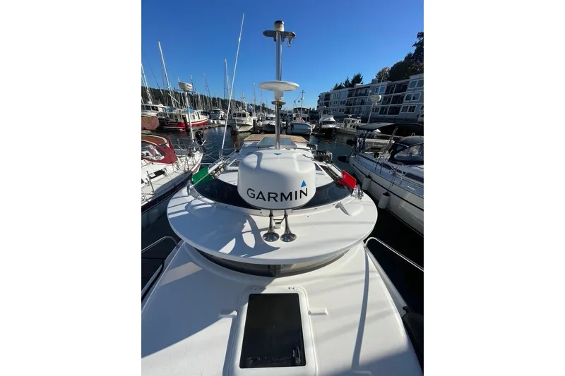 Slide: The Image of 2018 Ranger Tug R-27 with Garmin equipment docked at a marina. - 37