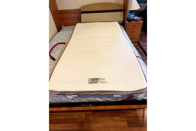Slide: The Image of A BedStory mattress topper on a wooden bed in a cozy bedroom setting. - 27
