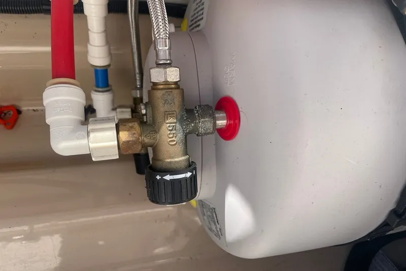 Slide: The Image of Close-up of plumbing components in a 2018 Ranger Tug R-27 boat. - 30