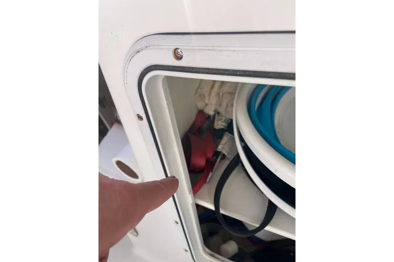 Slide: The Image of Storage compartment on 2018 Ranger Tug R-27 boat with various items inside. - 35