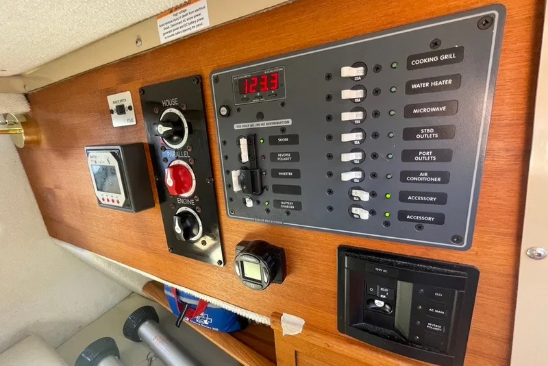 Slide: The Image of Electrical control panel of a 2018 Ranger Tug R-27 boat, featuring switches and gauges. - 28