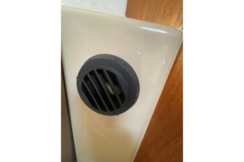 Slide: The Image of Vent on 2018 Ranger Tug R-27 boat interior, featuring beige panel and wooden trim. - 21