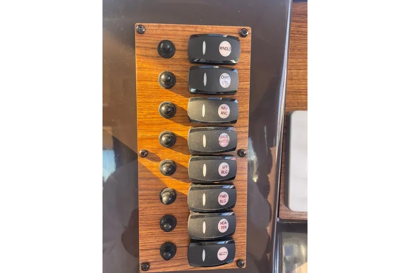 Slide: The Image of Control panel of a 2018 Ranger Tug R-27 boat with labeled switches. - 18