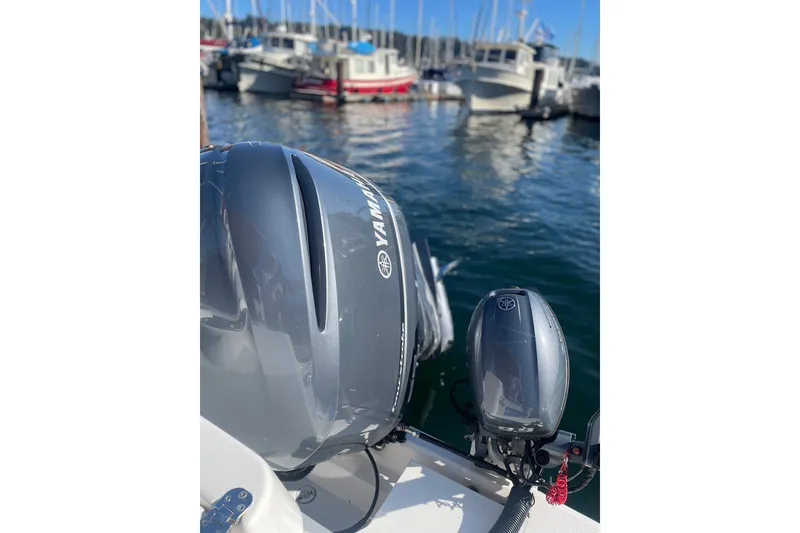 Slide: The Image of 2018 Ranger Tug R-27 with Yamaha outboard motor in marina setting. - 7