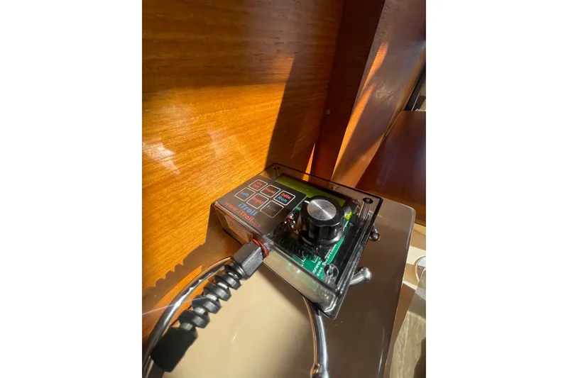 Slide: The Image of Control panel inside a 2018 Ranger Tug R-27 boat, featuring a knob and buttons. - 17