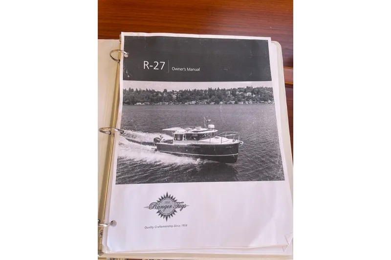 Slide: The Image of Owner's manual for 2018 Ranger Tug R-27 boat, featuring a cover image of the vessel. - 40