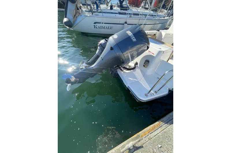 Slide: The Image of 2018 Ranger Tug R-27 with outboard motor docked at marina. - 4