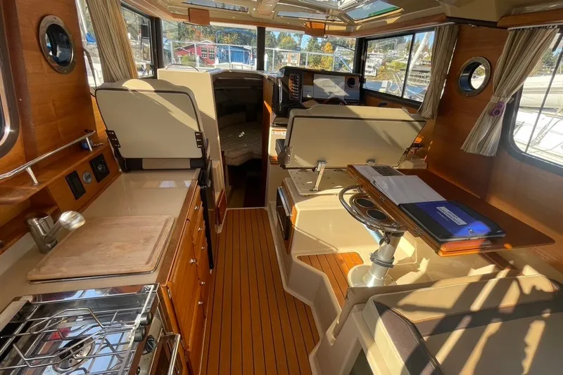 Slide: The Image of Interior of 2018 Ranger Tug R-27 boat with wood accents and modern amenities. - 9