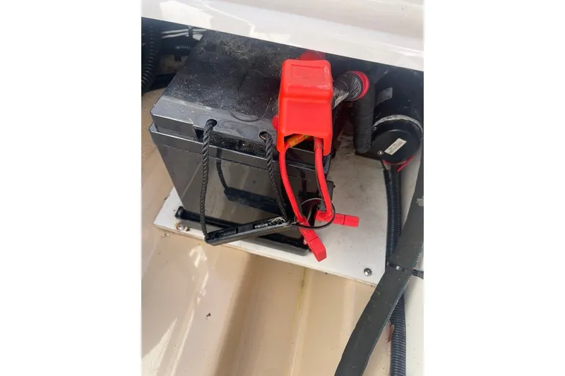 Slide: The Image of Battery compartment of a 2018 Ranger Tug R-27 boat with red cables. - 31