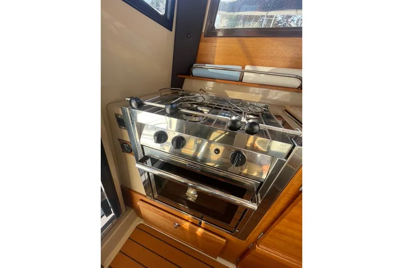 Slide: The Image of 2018 Ranger Tug R-27 interior kitchen with stainless steel stove and oven. - 14