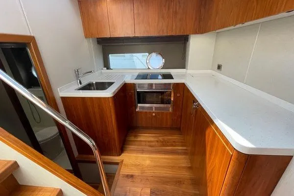 Slide: The Image of Luxurious Sunseeker Predator 57 yacht kitchen, 2016 model, featuring sleek wood cabinetry and modern appliances. - 29