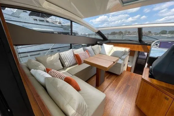 Slide: The Image of Luxurious interior of 2016 Sunseeker Predator 57 yacht with plush seating and wooden accents. - 13