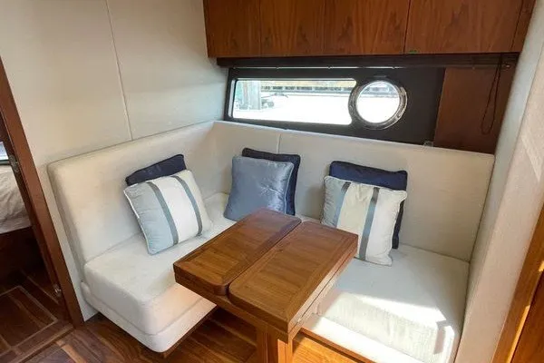 Slide: The Image of Luxurious interior seating area on 2016 Sunseeker Predator 57 yacht with cushions and wooden table. - 30