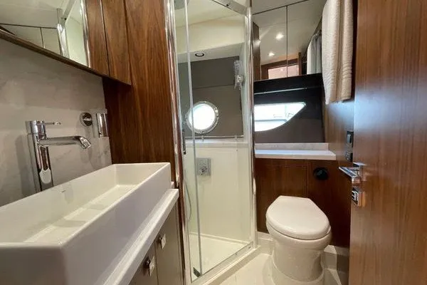 Slide: The Image of Luxurious bathroom in 2016 Sunseeker Predator 57 yacht with modern fixtures and wood accents. - 33